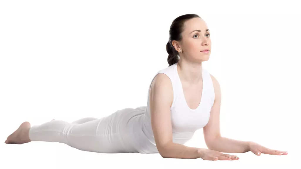 "Yoga woman arching back in Cobra Pose with hands firmly planted."