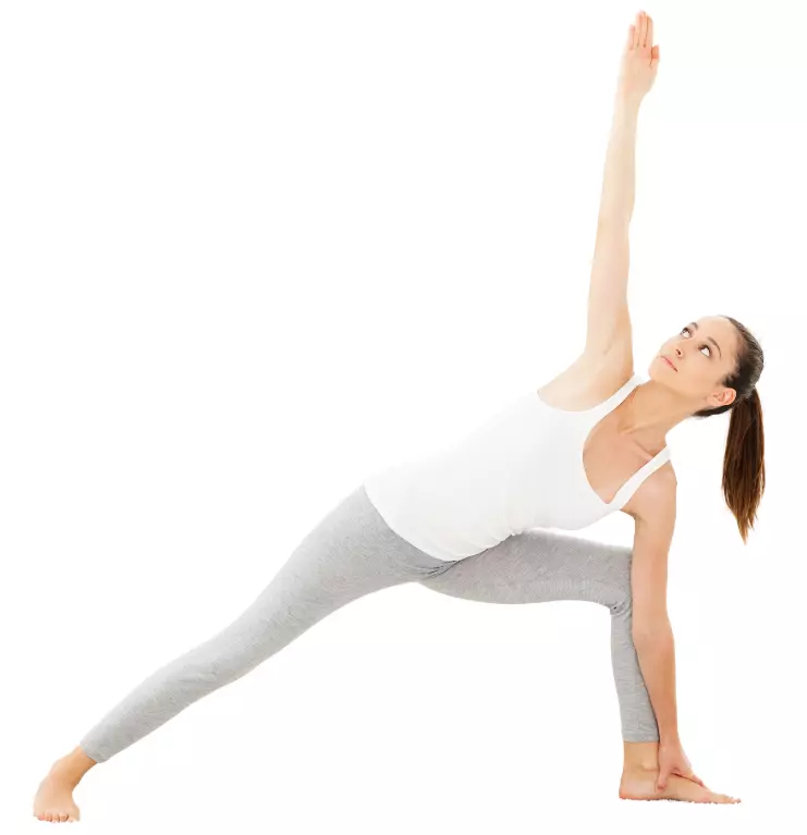 "Yoga practitioner in Extended Side Angle pose with bottom hand on block."