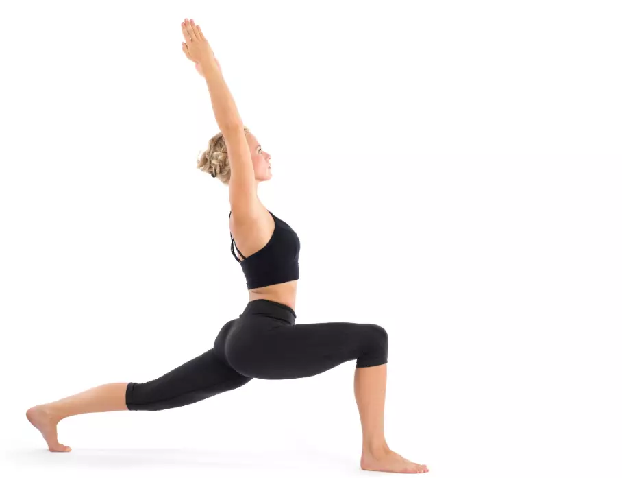 "Yoga practitioner in High Lunge pose with left leg forward and lifted."