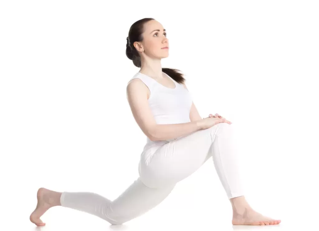 "Yoga practitioner in Low Lunge pose with right leg forward."