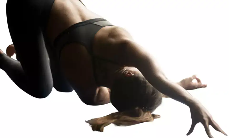 "Yoga woman stretching shoulder by threading one arm through legs."