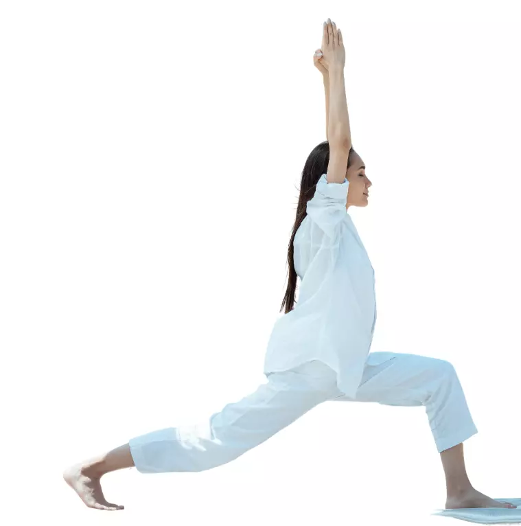 "Yoga practitioner in Warrior I pose with arms reaching up."