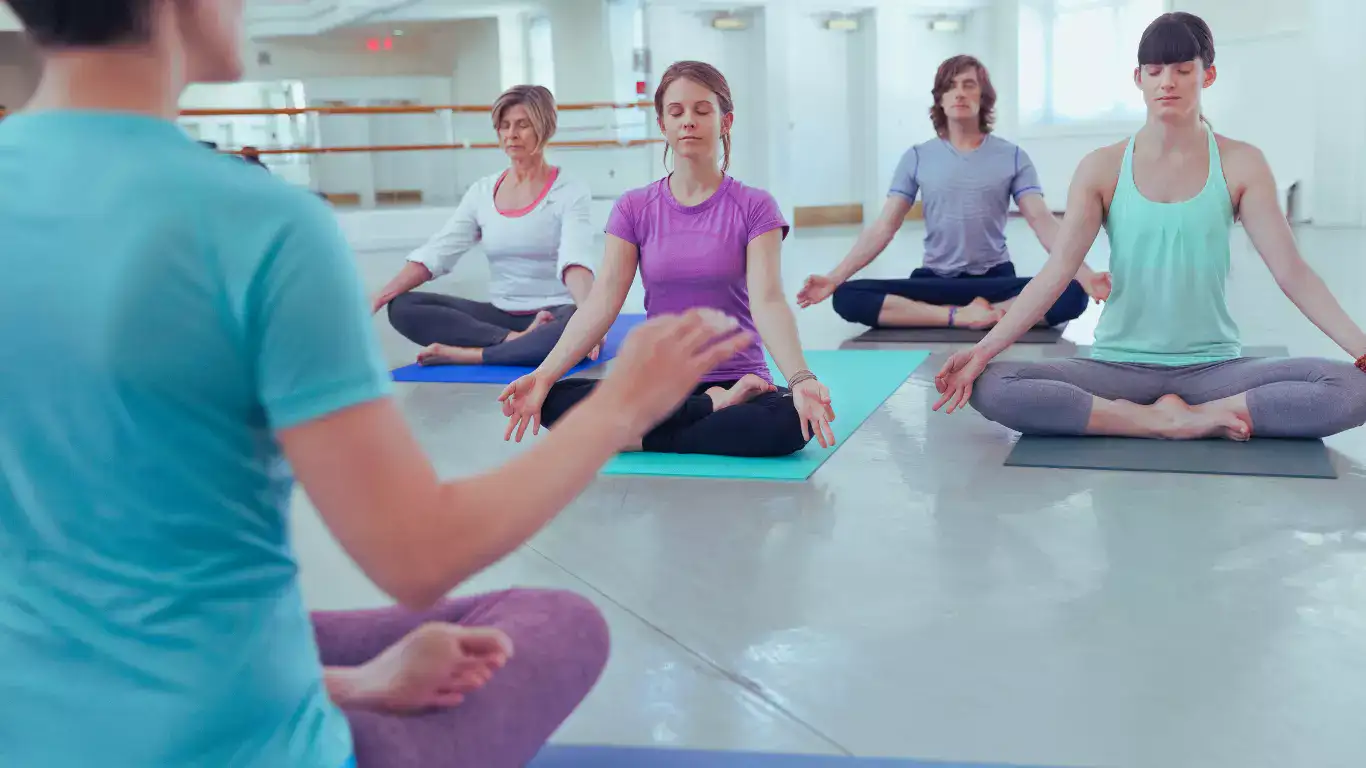 Students practicing hot yoga in heated studio